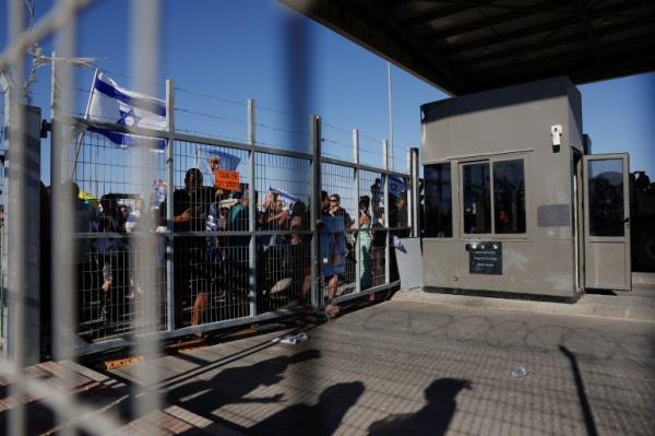 Protesters gather outside Sde Teiman detention facility after some of them broke in, after Israeli military police arrived at the site as part of an investigation into the suspected abuse of a Palestinian detainee